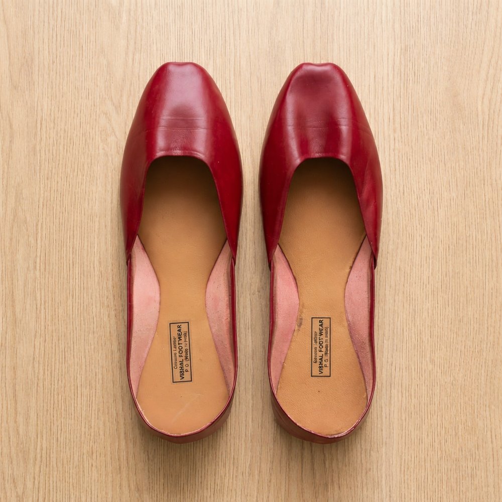 Women wearing maroon leather flats with comfortable fit and elegant square toe design