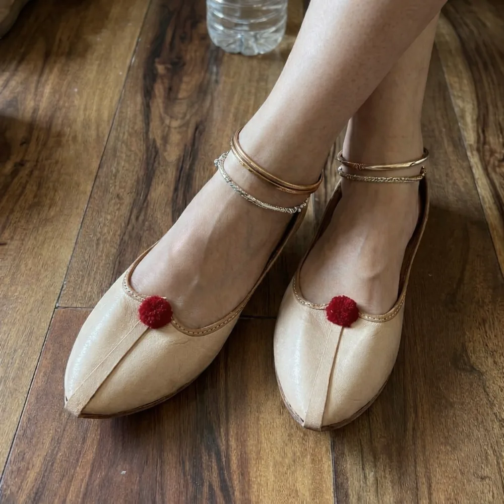 Soft pure leather Punjabi jutti for women in beige with red pom pom, handcrafted comfortable ethnic footwear for daily and festive wear