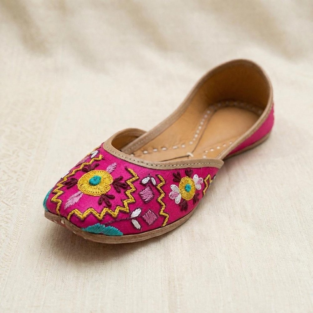 Pink floral embroidered jutti front view with detailed threadwork and traditional design