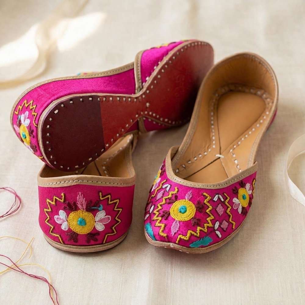 Handcrafted pink silk jutti side angle showing intricate floral embroidery and mojari style
