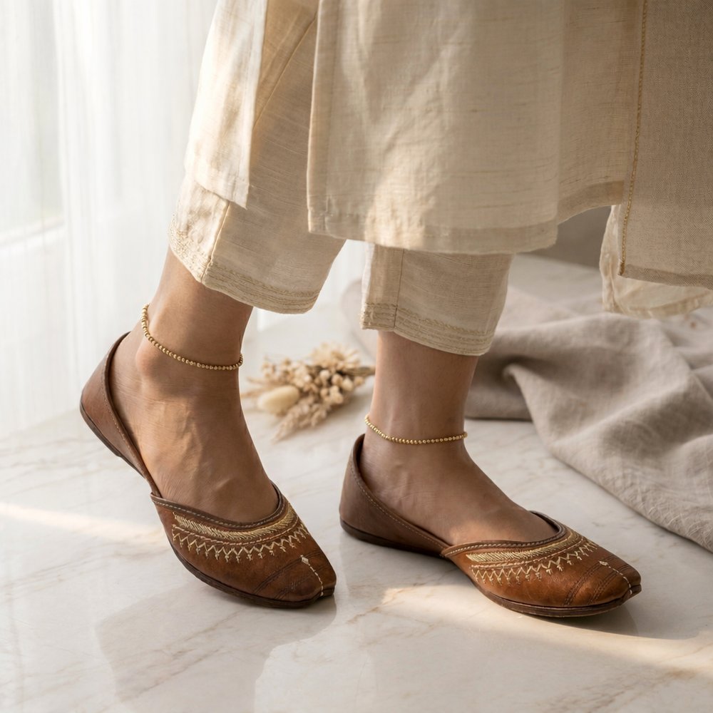 Side angle view of handcrafted brown leather jutti for women