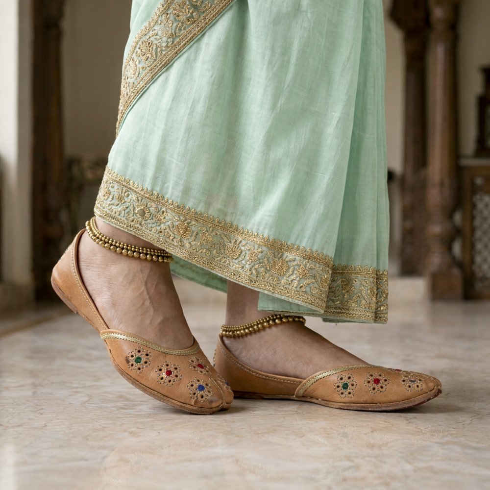 Women wearing tan leather jutti with saree, traditional ethnic footwear styling